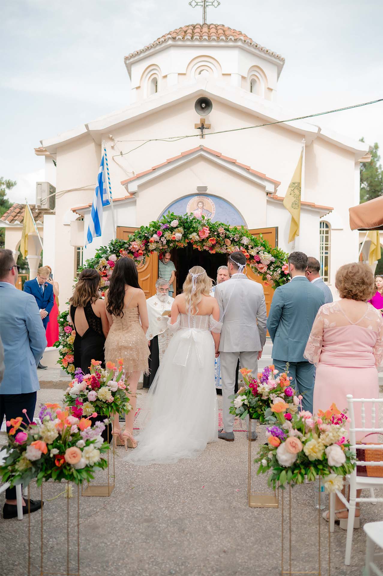 Guests seated during the ceremony, surrounded by olive trees and warm light.